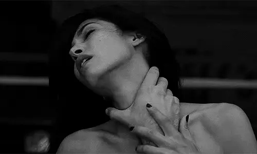 Gently place your hand on her throat