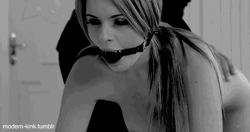 You put a gag in her mouth and decide to use this opportunity to spank her ass. Your hand strikes her hard but all you can hear are muffled moans and cries.