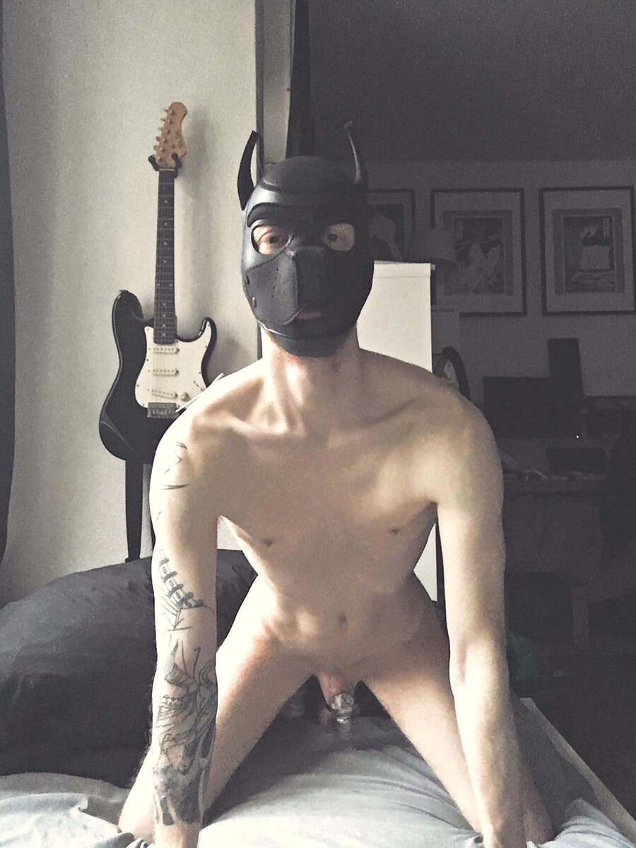 Stripping naked and dropping to your knees, you greet your owner with enthusiasm, evidenced by your wagging, caged cock.