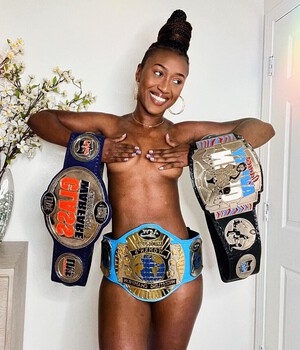 (Signature) The champ poses with her belt